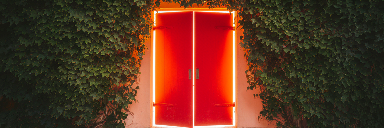 Closed bright red door symbolizing stop